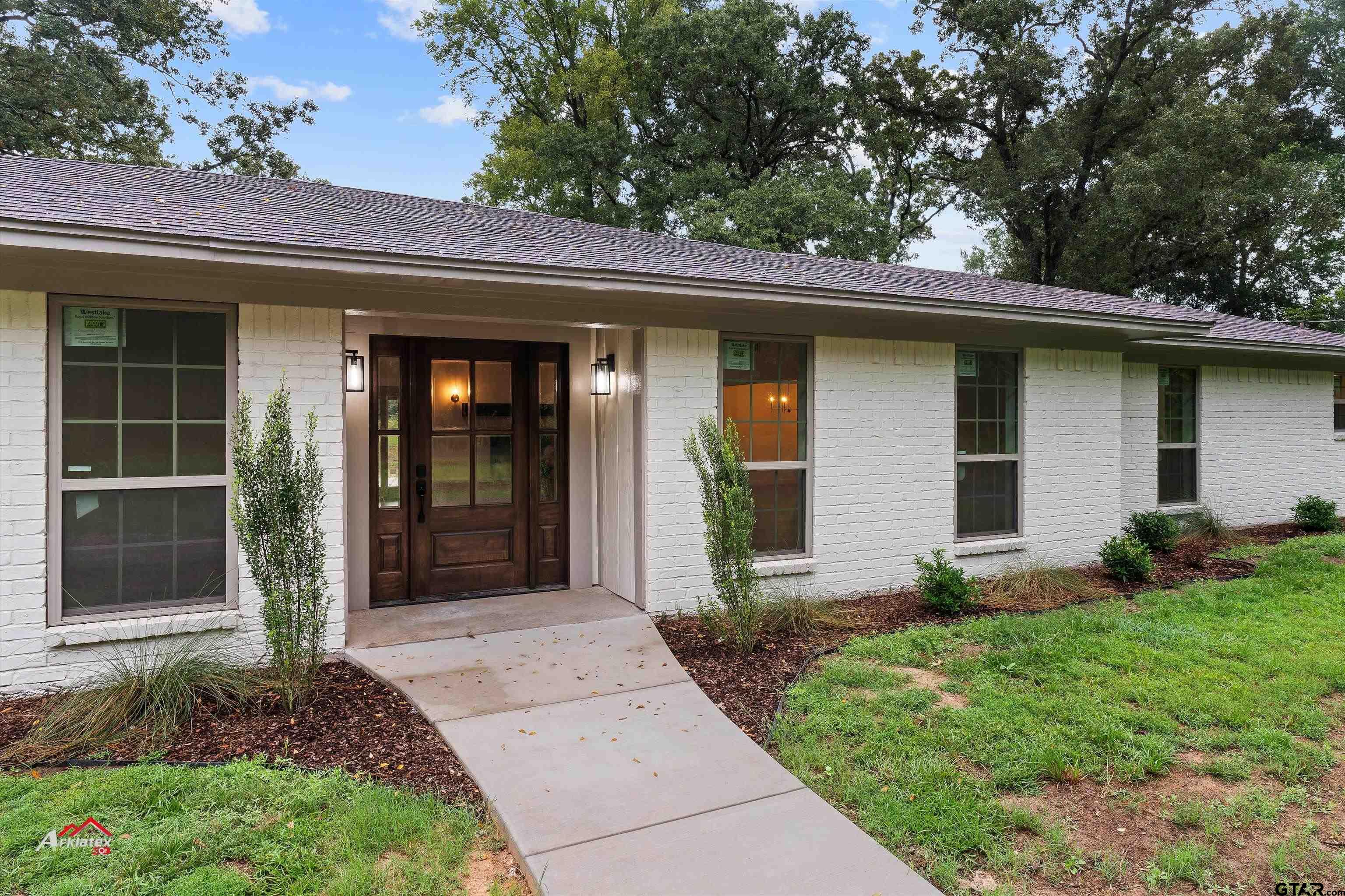875 Old Town Road Marshall, TX 75672 - Photo 1 of 34 a view of a house with a yard and plants