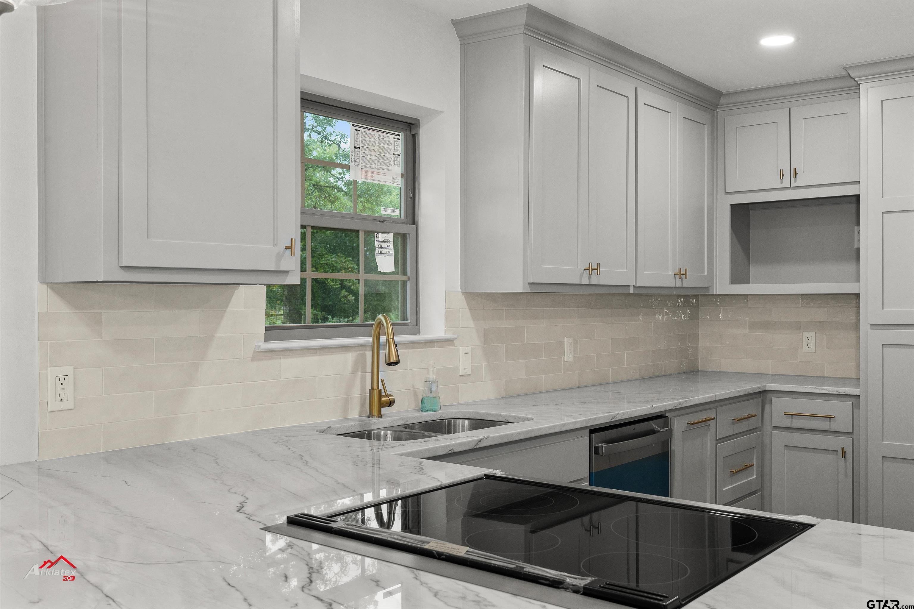 875 Old Town Road Marshall, TX 75672 - Photo 15 of 34 a kitchen with stainless steel appliances granite countertop a sink a stove and a microwave