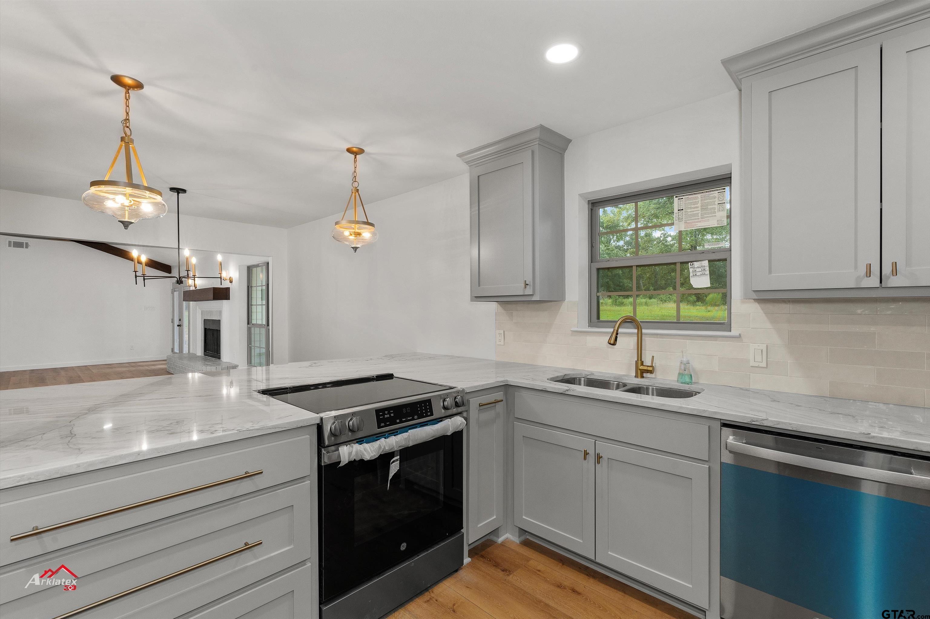 875 Old Town Road Marshall, TX 75672 - Photo 16 of 34 a kitchen with a sink and a stove