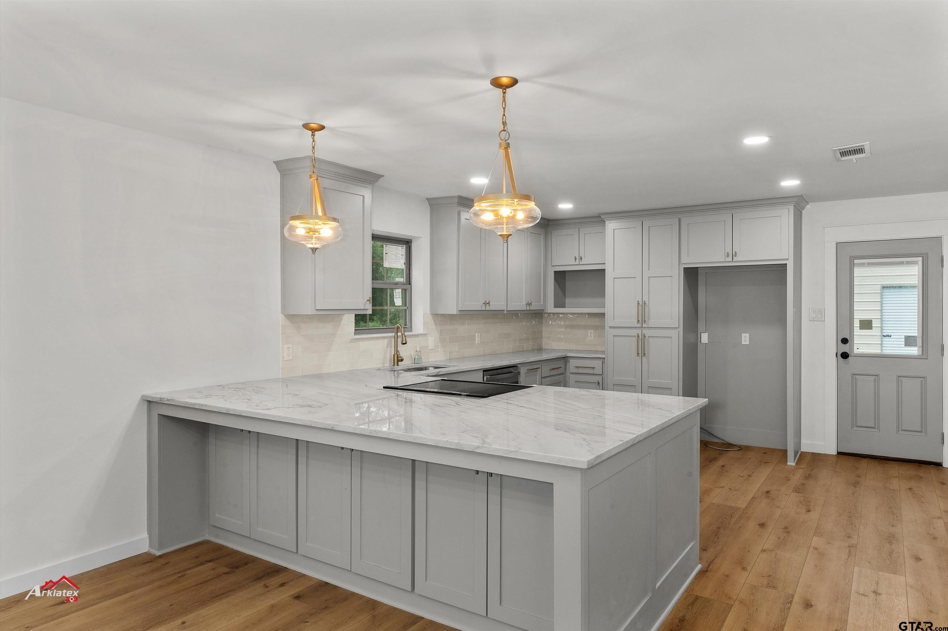 875 Old Town Road Marshall, TX 75672 - Photo 17 of 34 a kitchen with a sink a counter space and cabinets