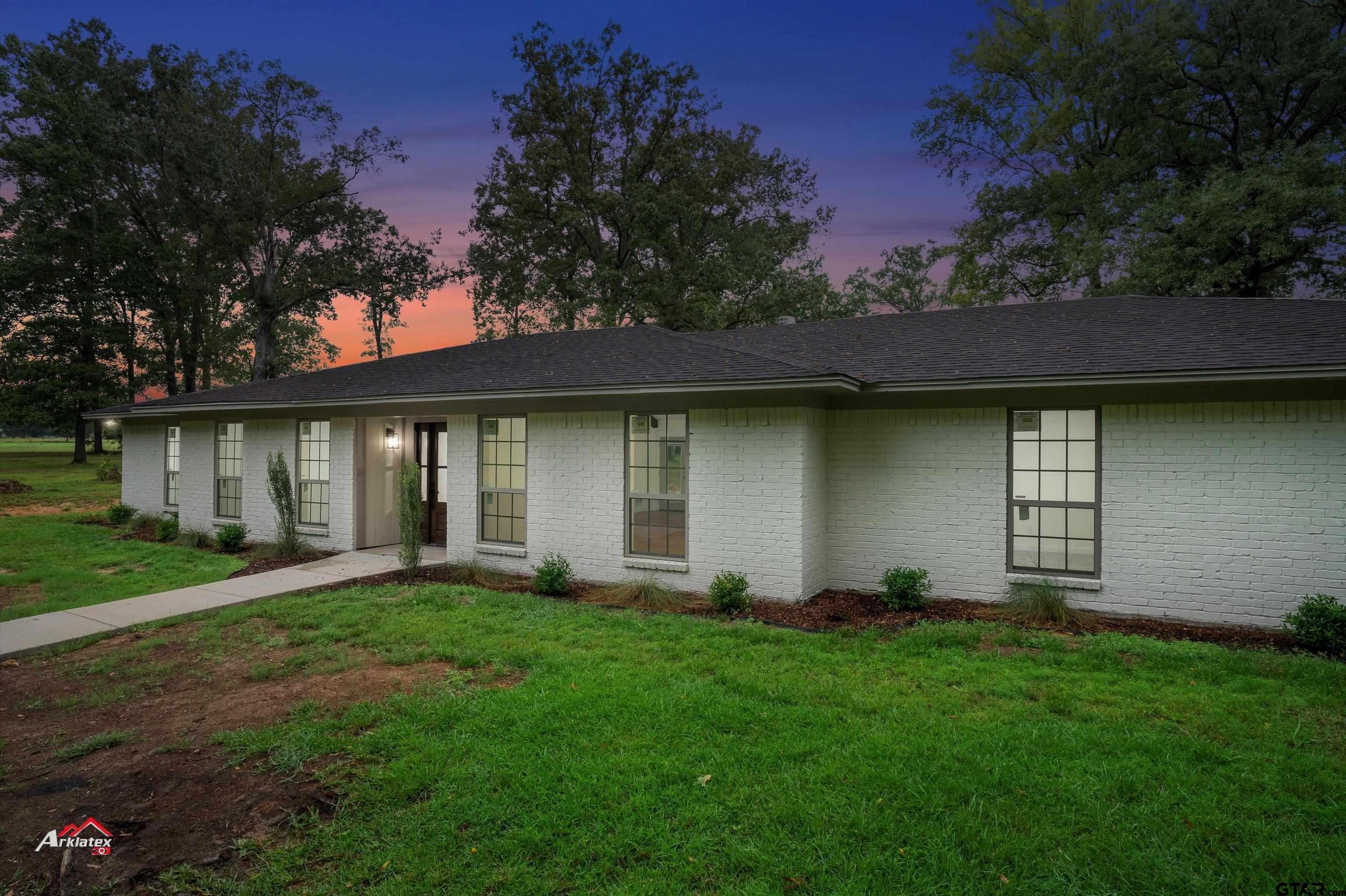 875 Old Town Road Marshall, TX 75672 - Photo 2 of 34 a view of a yard in front of a house with large tree