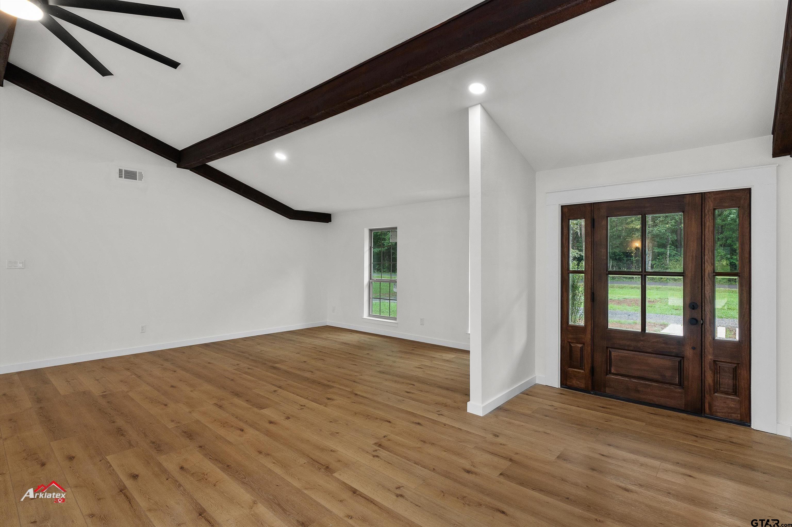 875 Old Town Road Marshall, TX 75672 - Photo 8 of 34 a view of an empty room with wooden floor and a window