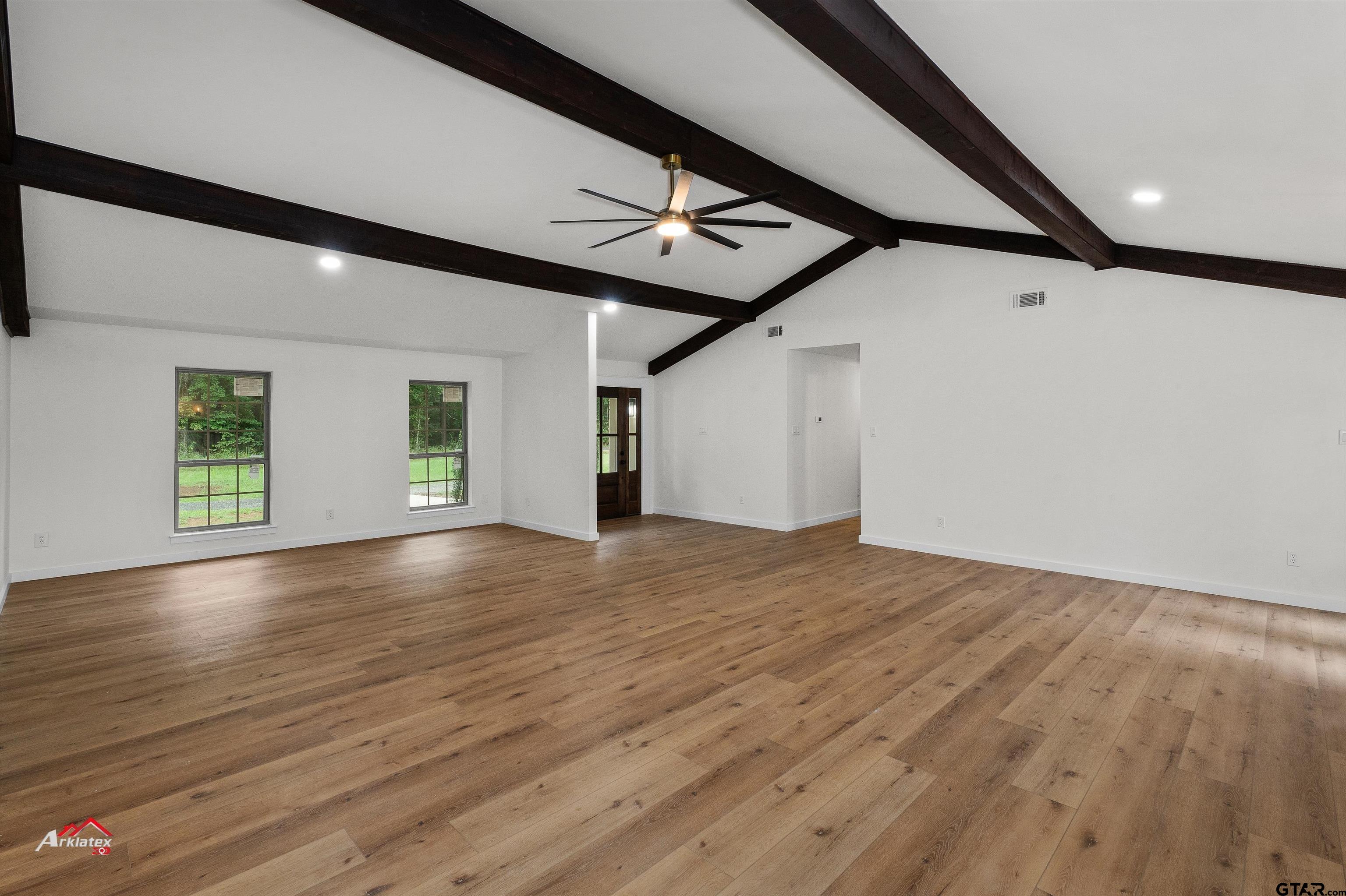 875 Old Town Road Marshall, TX 75672 - Photo 10 of 34 a view of an empty room with wooden floor and a window