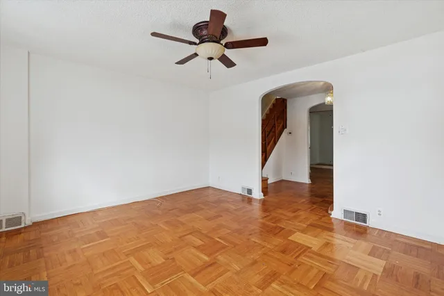 a view of an empty room with a ceiling fan