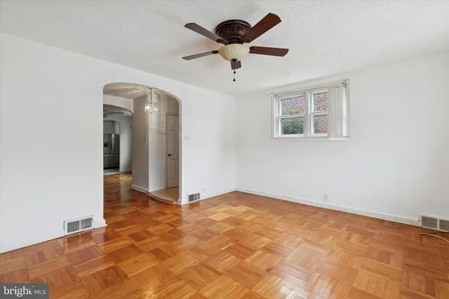 a view of empty room with stairs and wooden floor