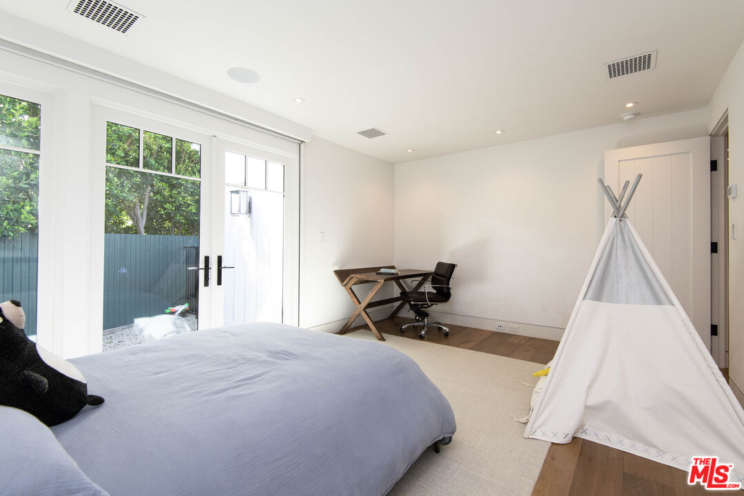 13705 Romany Drive Pacific Palisades, CA 90272 - Photo 32 of 54 a bedroom with a bed and a large window