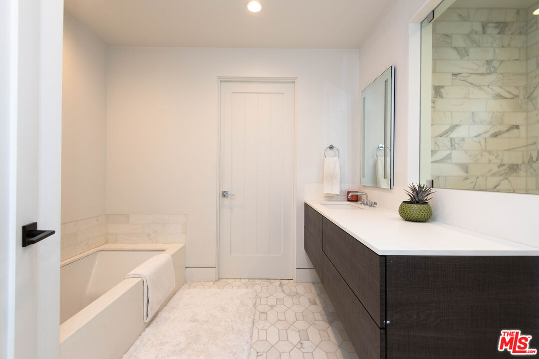 13705 Romany Drive Pacific Palisades, CA 90272 - Photo 34 of 54 a bathroom with a sink a bathtub and a shower