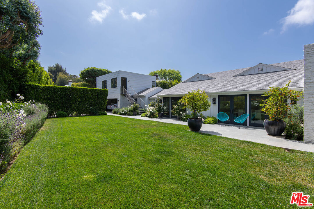 13705 Romany Drive Pacific Palisades, CA 90272 - Photo 42 of 54 a front view of a house with a garden and porch