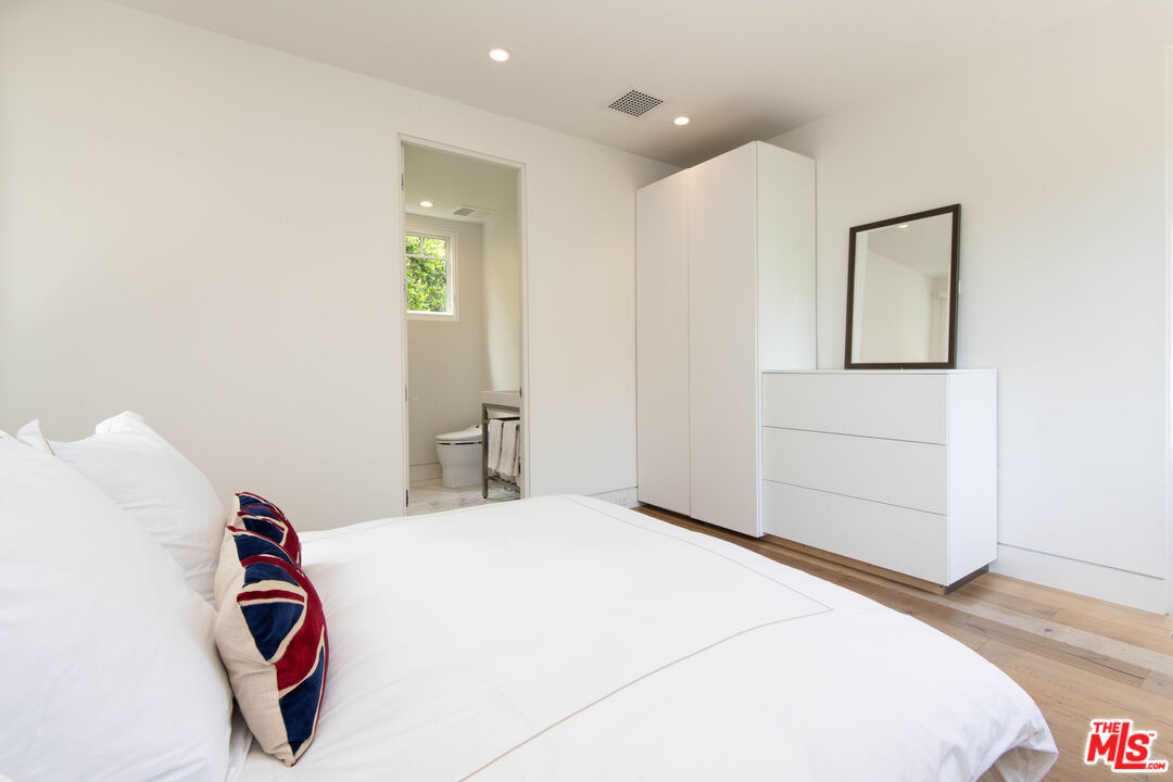 13705 Romany Drive Pacific Palisades, CA 90272 - Photo 46 of 54 a bedroom with a bed and a painting on the wall