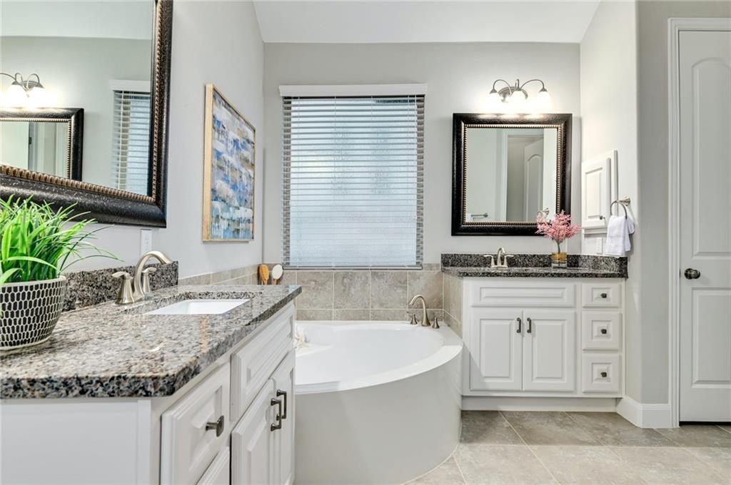204 Maxwell Way, Unit 39 Austin, TX 78738 - Photo 14 of 26 a bathroom with granite countertop a sink and a mirror