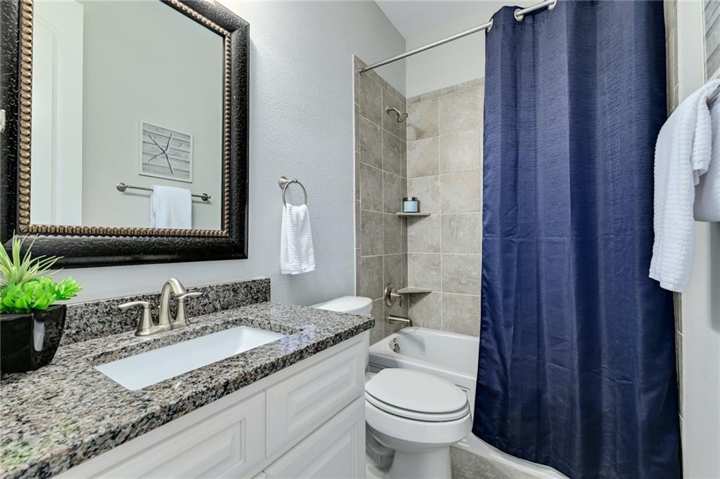 204 Maxwell Way, Unit 39 Austin, TX 78738 - Photo 18 of 26 a bathroom with a granite countertop sink toilet and shower