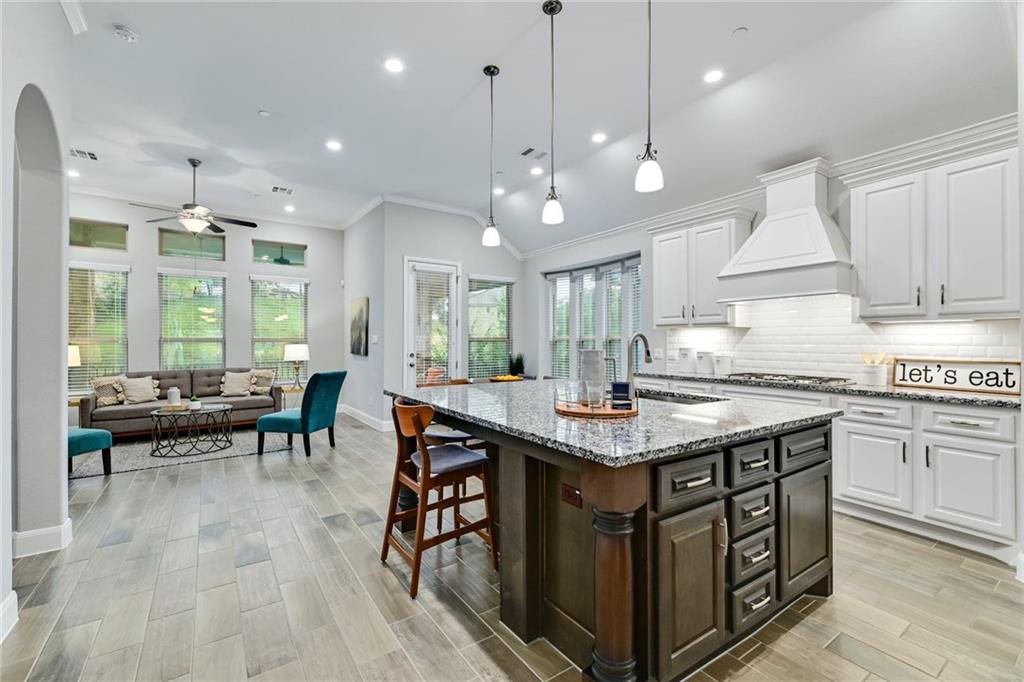 204 Maxwell Way, Unit 39 Austin, TX 78738 - Photo 6 of 26 a kitchen with stainless steel appliances granite countertop a stove a refrigerator and a wooden cabinets