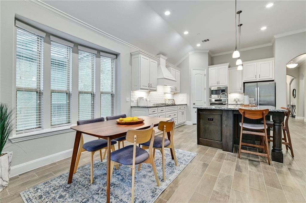 204 Maxwell Way, Unit 39 Austin, TX 78738 - Photo 8 of 26 a kitchen with a table and chairs in it
