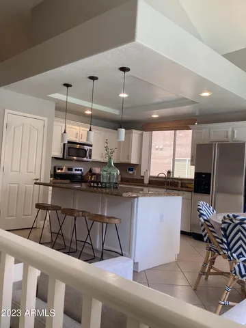 a kitchen with stainless steel appliances kitchen island granite countertop a sink and cabinets