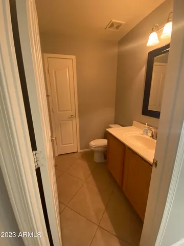 a bathroom with a sink a toilet a mirror and vanity