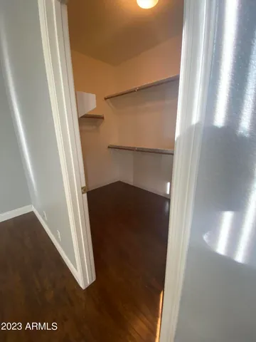 a living room with furniture flat screen tv and wooden floor