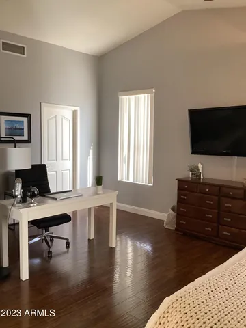 a bedroom with a bed and a dresser