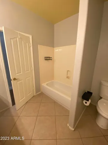 a spacious bathroom with a double vanity sink a mirror and a bathtub