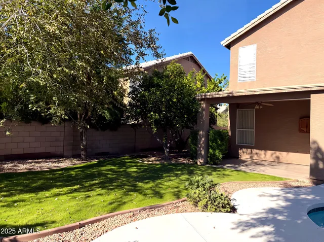 a view of a house with swimming pool and sitting area