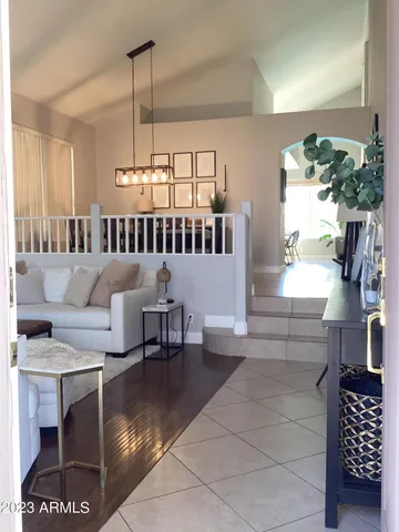 a view of a livingroom with furniture and staircase