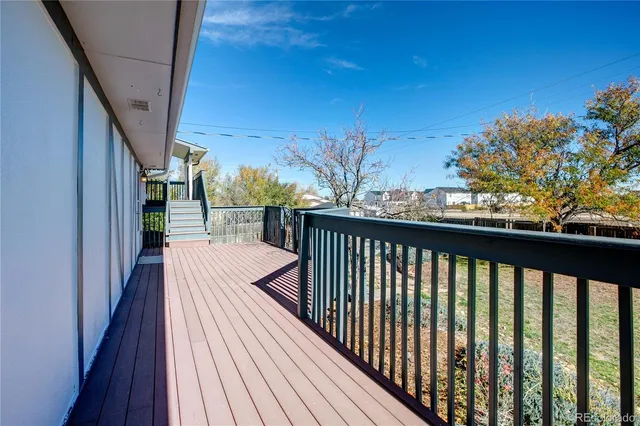 a view of a balcony with wooden floor