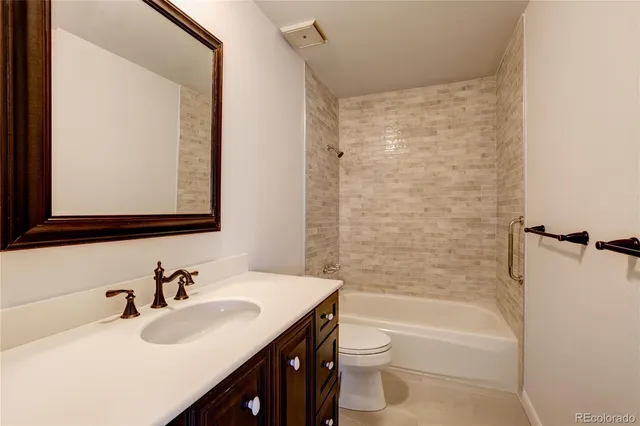 a bathroom with a sink mirror toilet and bathtub