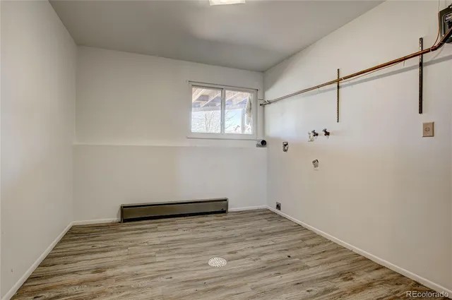a view of a room with wooden floor and cabinet