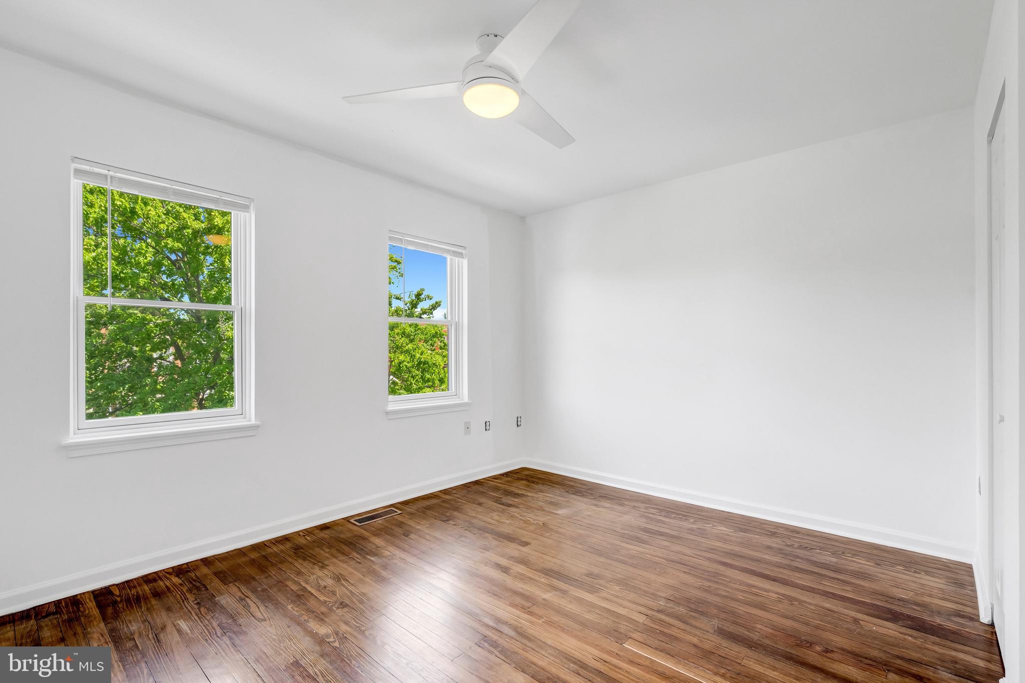 1749 L Street Northeast Washington, DC 20002 - Photo 13 of 24 an empty room with wooden floor and windows