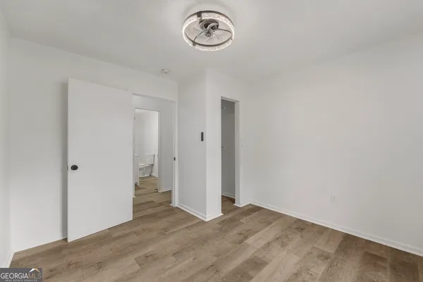 a view of a room with wooden floor