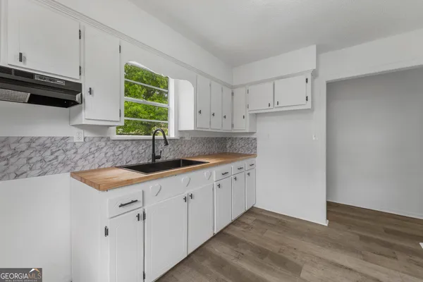 a kitchen with sink cabinets and window