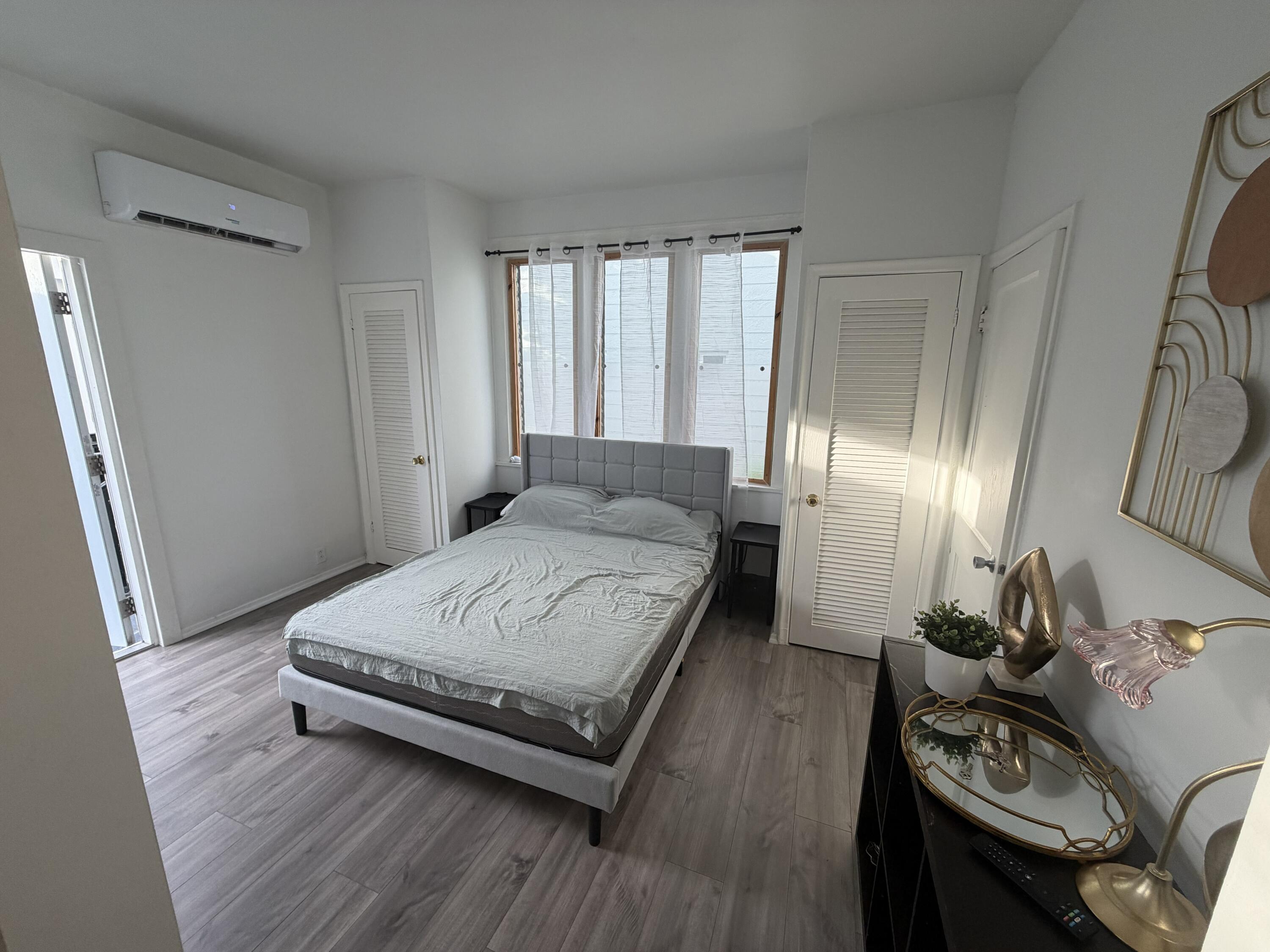 811 Southeast 16th Street Fort Lauderdale, FL 33316 - Photo 22 of 25 a spacious bedroom with a bed and wooden floor