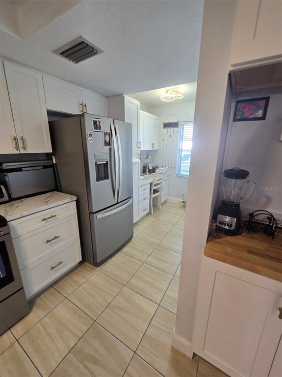 6800 Placida Road, Unit 167 Englewood, FL 34224 - Photo 20 of 44 a kitchen with a refrigerator and cabinets