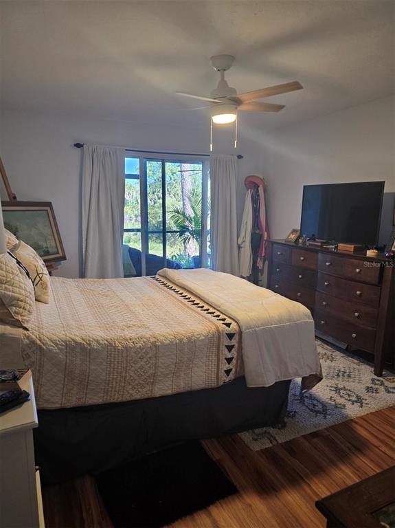 6800 Placida Road, Unit 167 Englewood, FL 34224 - Photo 25 of 44 a bedroom with a bed and a flat screen tv