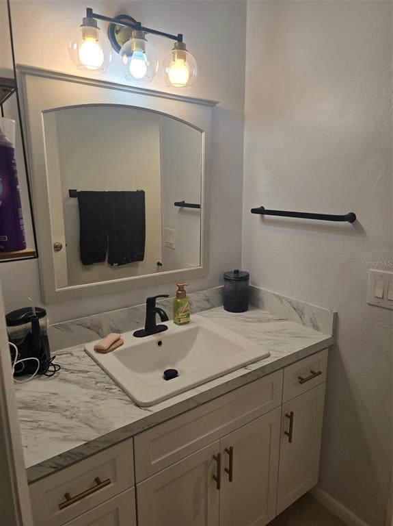 6800 Placida Road, Unit 167 Englewood, FL 34224 - Photo 27 of 44 a bathroom with a sink and a mirror