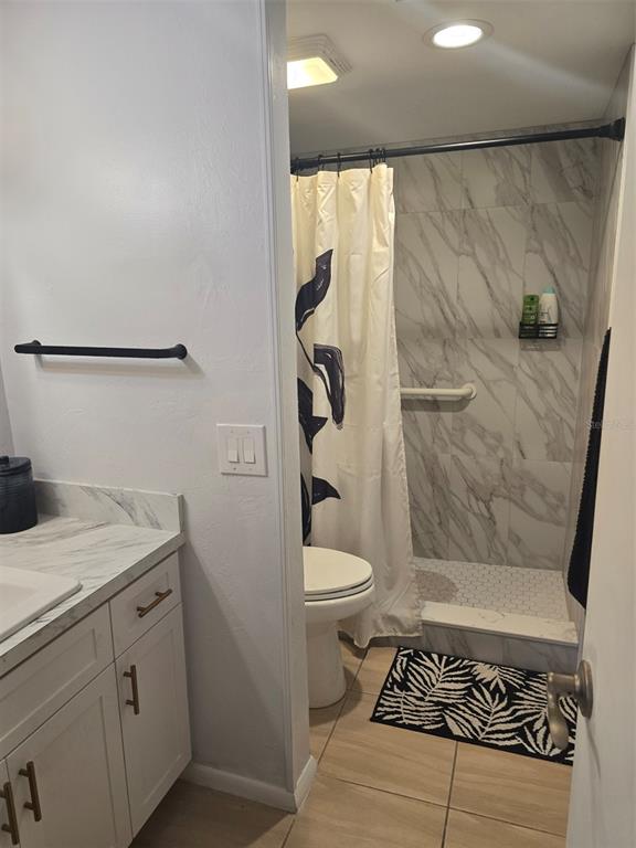 6800 Placida Road, Unit 167 Englewood, FL 34224 - Photo 28 of 44 a bathroom with a granite countertop sink toilet and shower