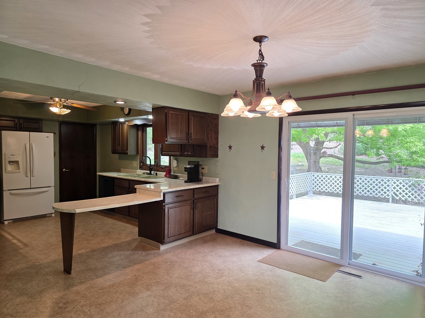 15510 Lomax Road Prophetstown, IL 61277 - Photo 7 of 24 a kitchen with kitchen island a large counter top a stove and a chandelier