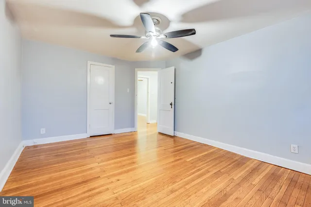 a view of an empty room with wooden floor
