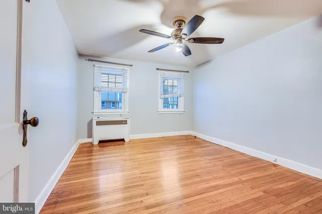 a view of a livingroom with a hardwood floor and a ceiling fan