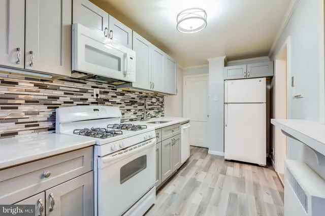 a kitchen with a stove top oven sink and cabinets
