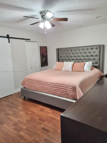 a bedroom with a bed and a ceiling fan