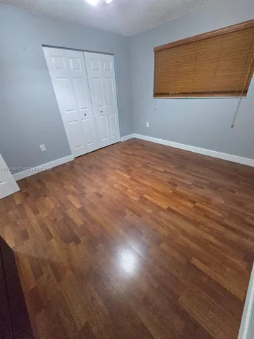 an empty room with wooden floor