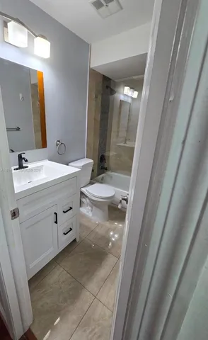 a bathroom with a double vanity sink toilet and shower