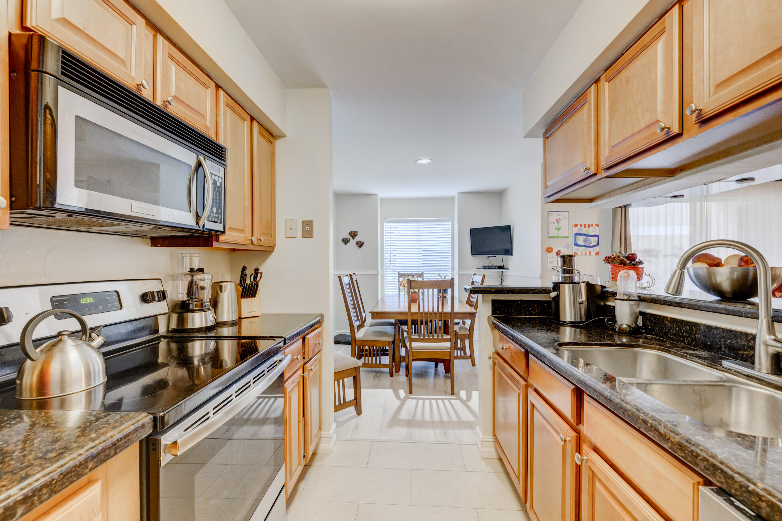 995 Riverside Drive, Unit 111 Coral Springs, FL 33071 - Photo 1 of 24 a kitchen filled counter top space a sink and cabinets