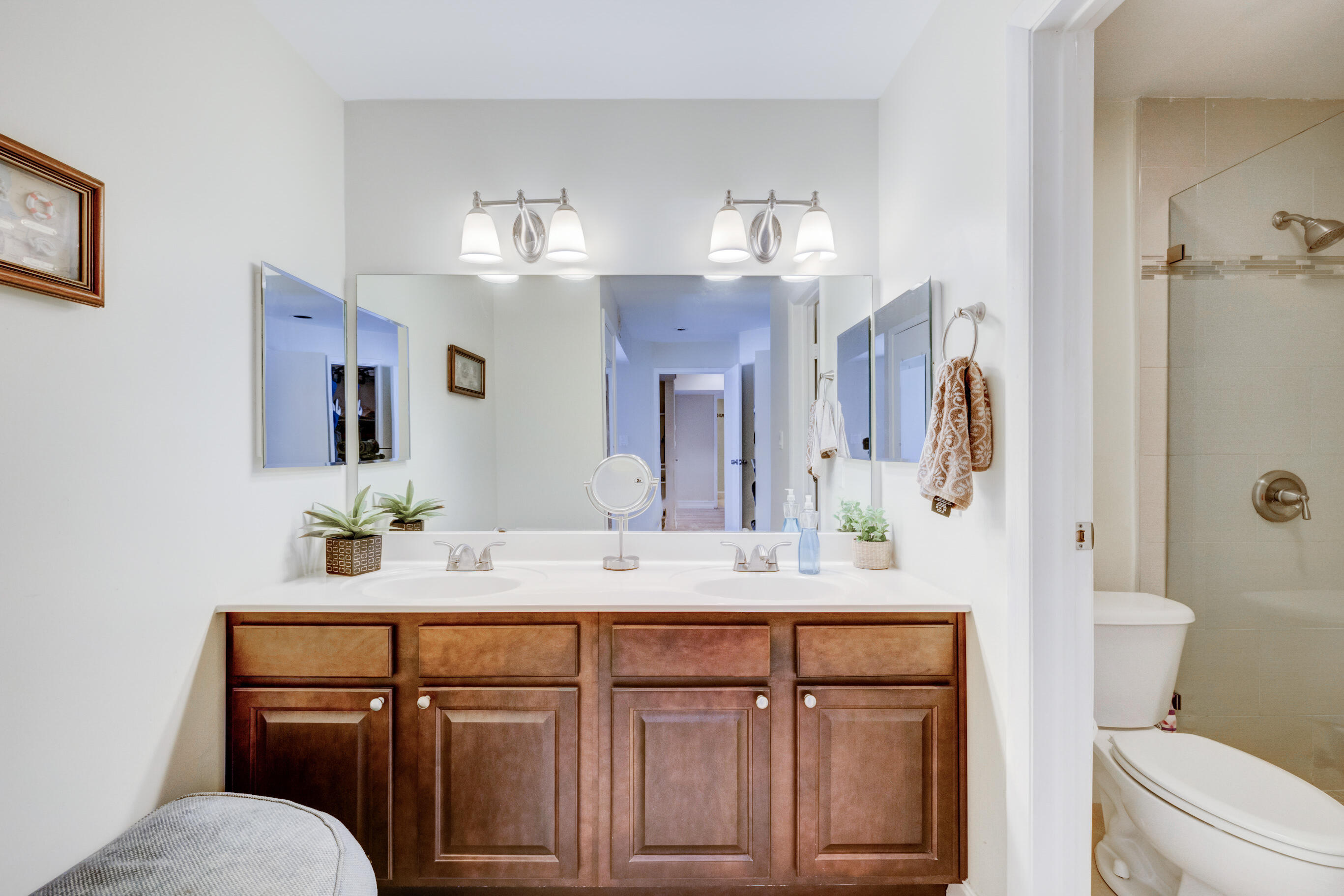 995 Riverside Drive, Unit 111 Coral Springs, FL 33071 - Photo 13 of 24 a bathroom with a sink vanity mirror and toilet