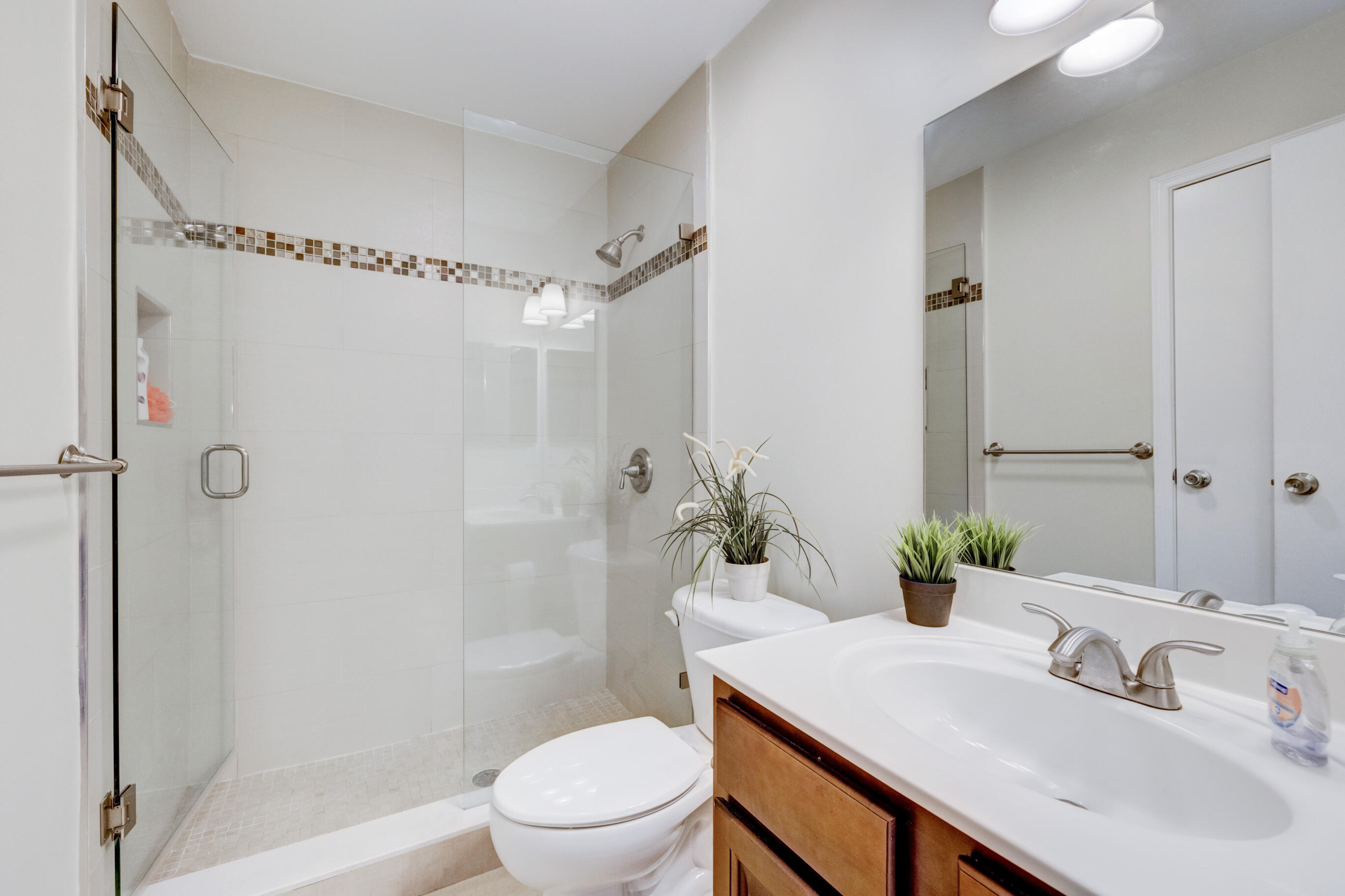 995 Riverside Drive, Unit 111 Coral Springs, FL 33071 - Photo 14 of 24 a bathroom with a sink toilet and shower