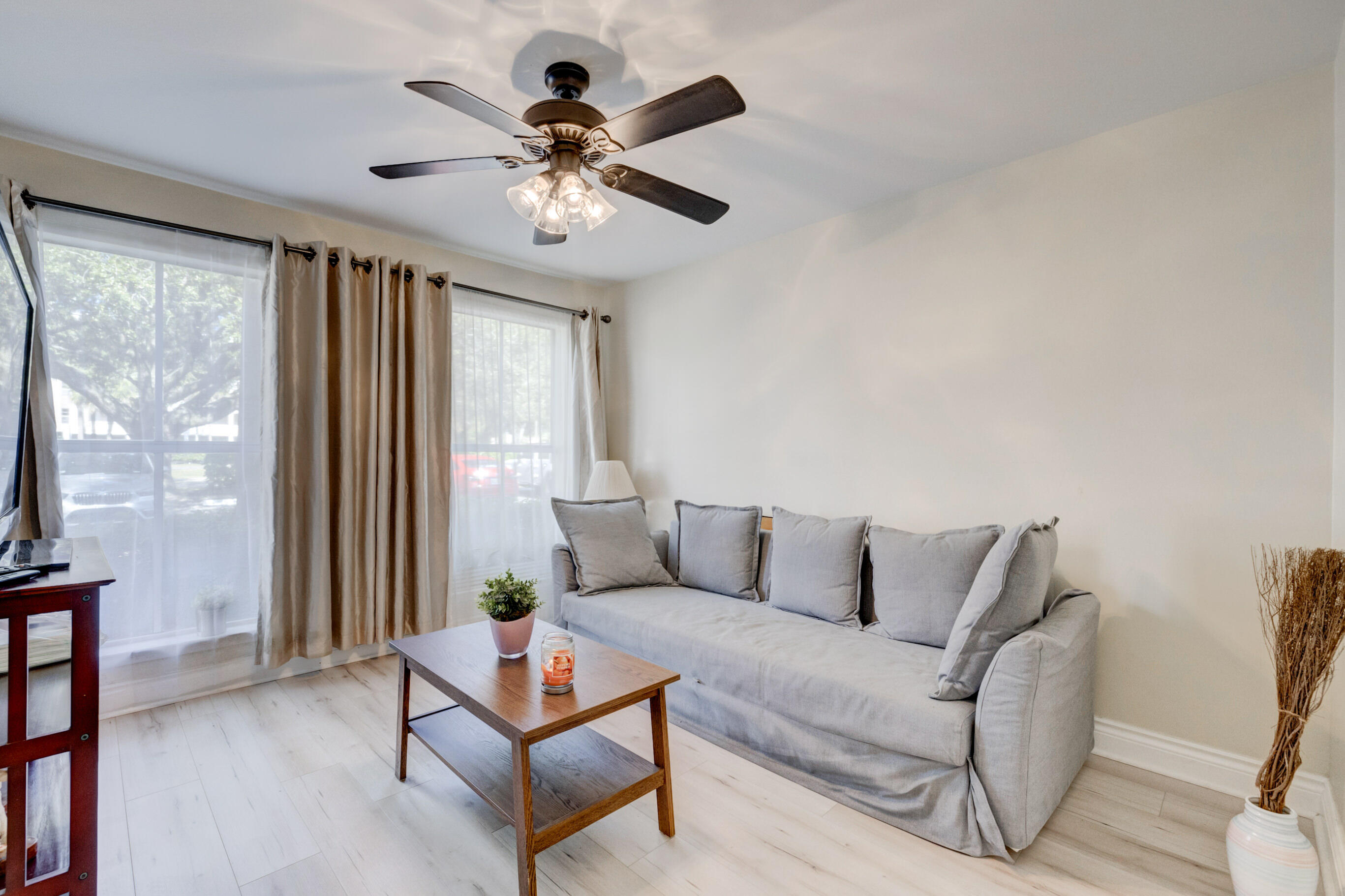995 Riverside Drive, Unit 111 Coral Springs, FL 33071 - Photo 16 of 24 a living room with furniture and a large window