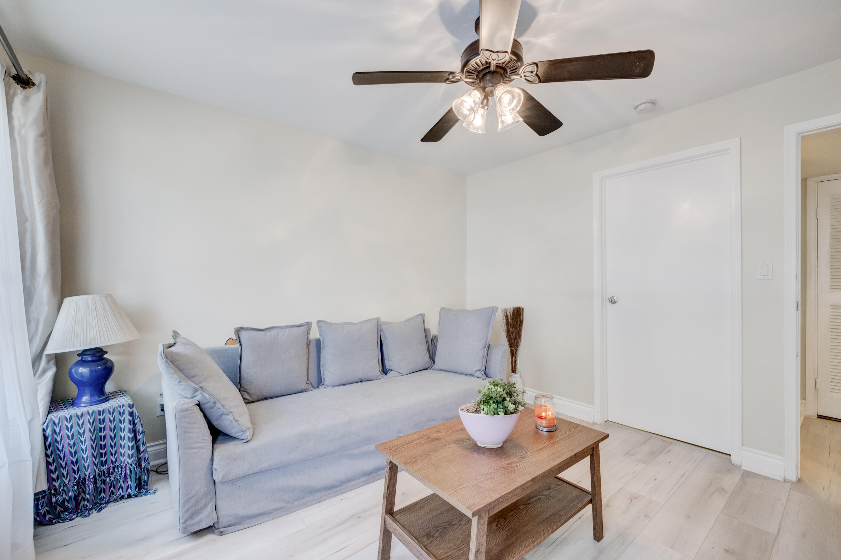 995 Riverside Drive, Unit 111 Coral Springs, FL 33071 - Photo 17 of 24 a living room with furniture and a lamp