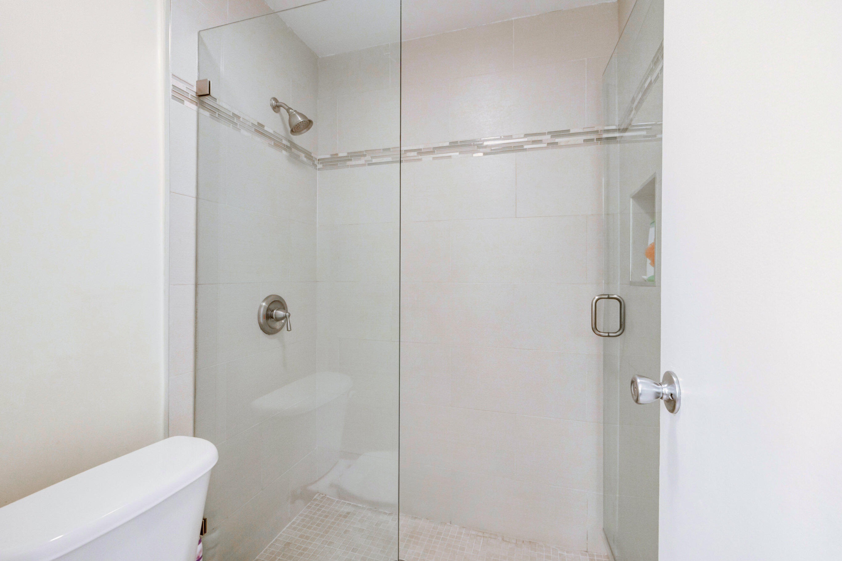995 Riverside Drive, Unit 111 Coral Springs, FL 33071 - Photo 18 of 24 a bathroom with a shower and a toilet