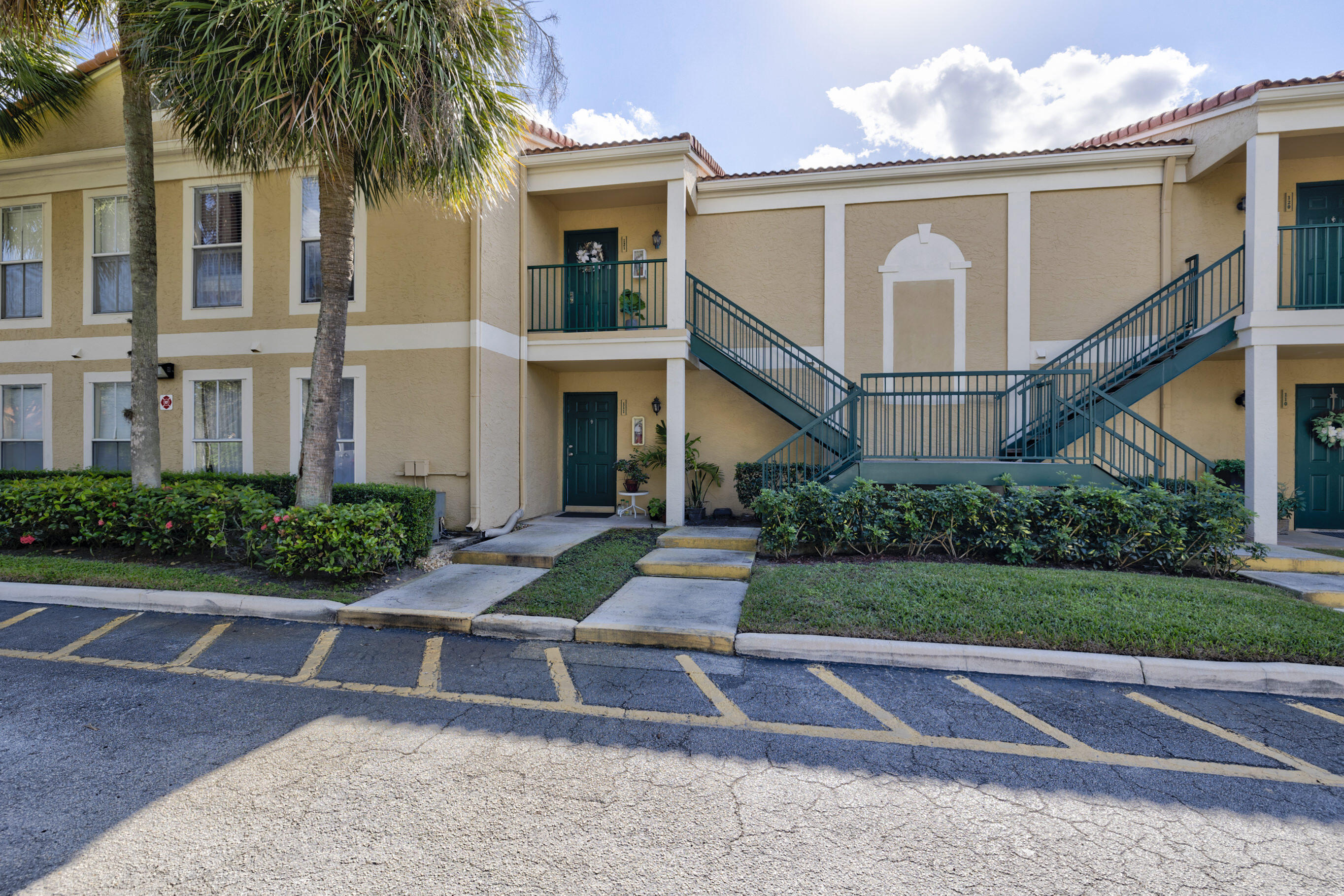995 Riverside Drive, Unit 111 Coral Springs, FL 33071 - Photo 2 of 24 a front view of house with yard and green space