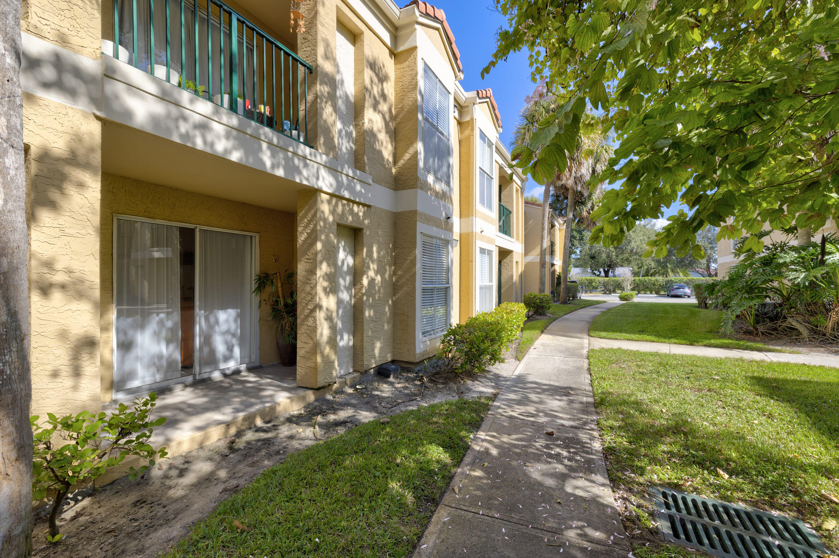 995 Riverside Drive, Unit 111 Coral Springs, FL 33071 - Photo 23 of 24 a view of a building with a yard